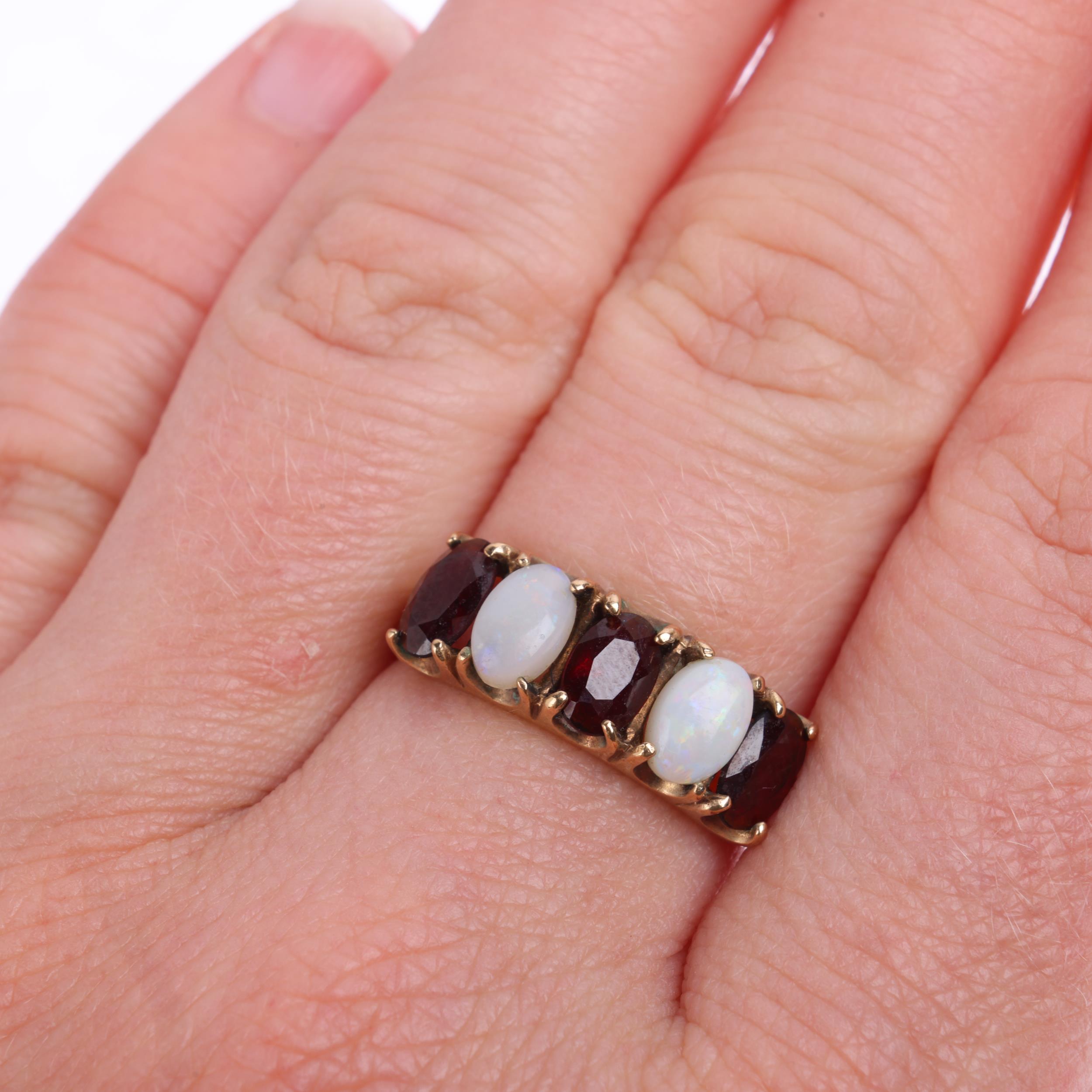 A 9ct gold five stone opal and garnet half hoop ring, maker W&G, Birmingham 1975, setting height 6. - Image 4 of 4