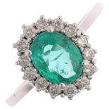 An emerald and diamond oval cluster ring, claw set with oval mixed-cut emerald and modern round