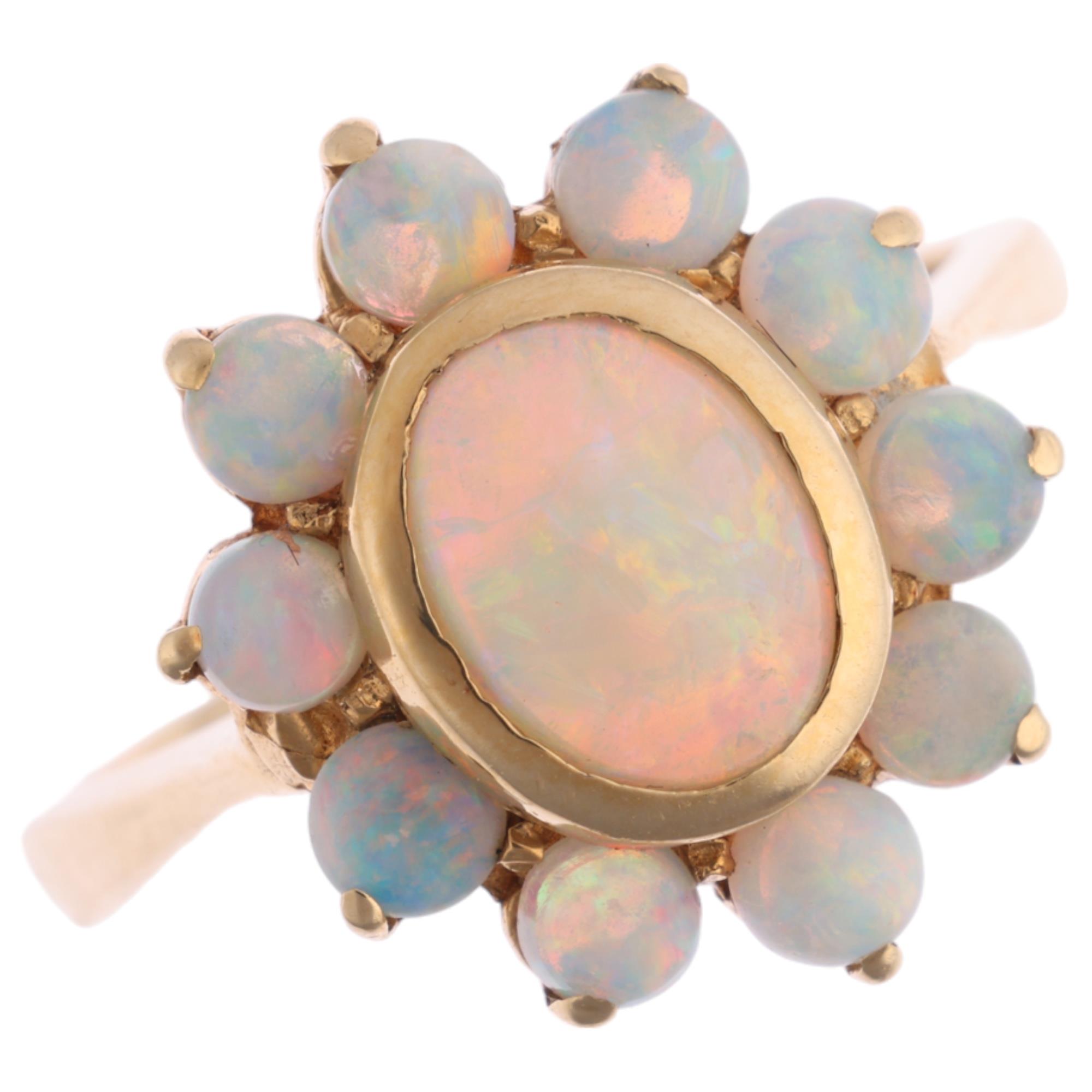 A 14ct gold opal flowerhead cluster ring, set with oval and round cabochon opals, setting height