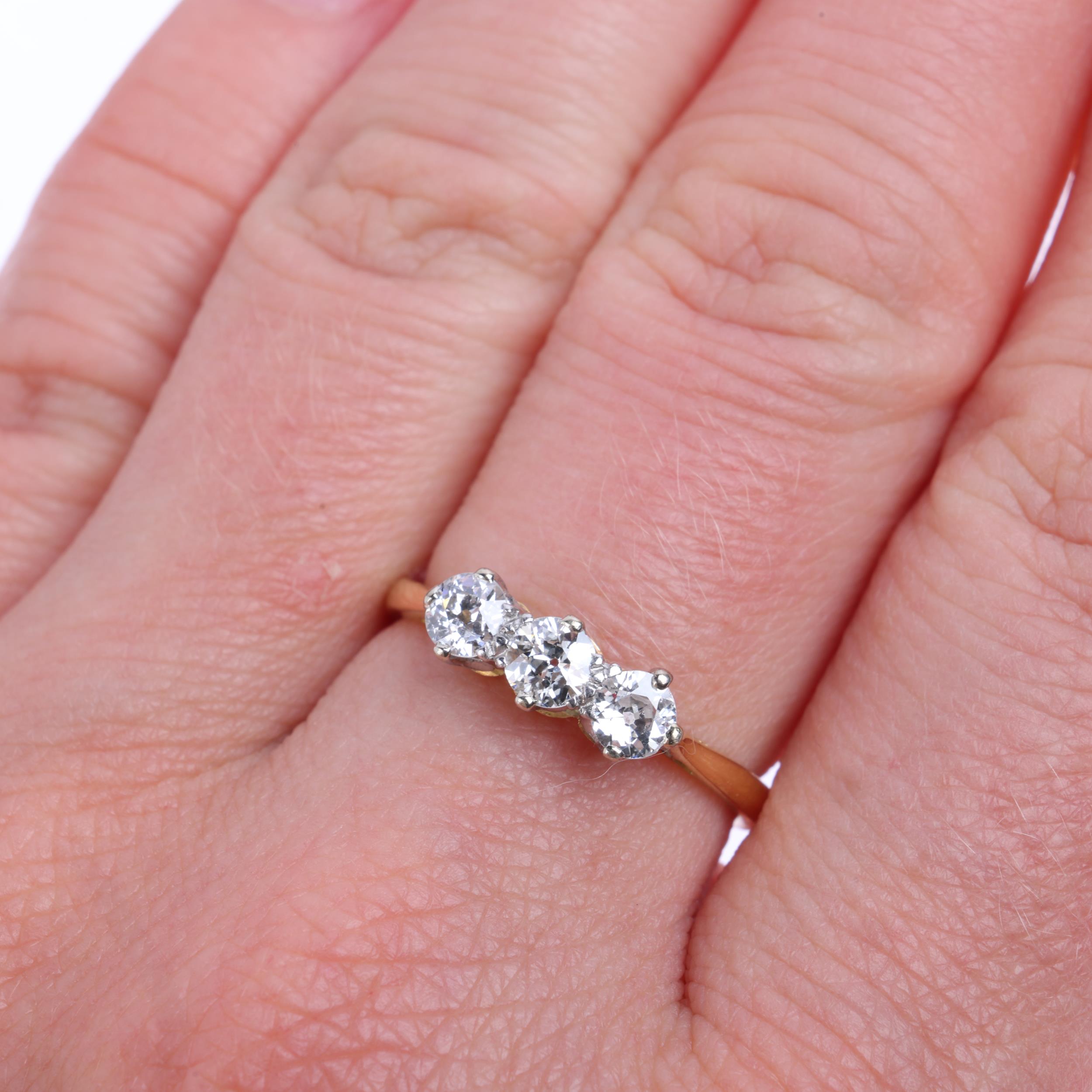 A three stone diamond ring, claw set with old European-cut diamonds, total diamond content approx - Image 4 of 4