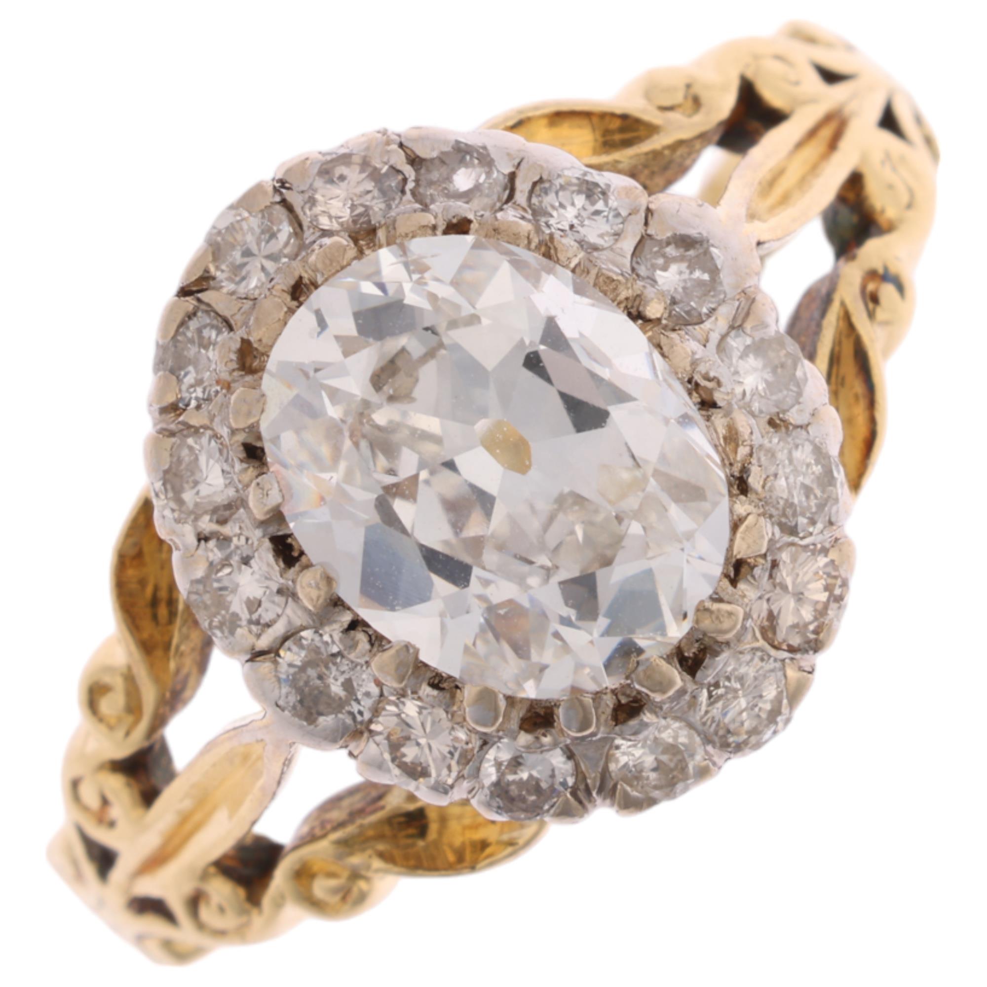 An 18ct gold 1.35ct lab grown diamond cluster ring, centrally claw set with 1.3ct oval mixed-cut lab