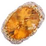 A large 18ct gold citrine and diamond floral dress ring, set with oval rose-cut citrine and single-