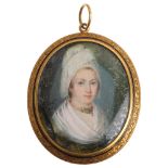A large Georgian oval portrait mourning locket pendant, circa 1800, the front having hand painted