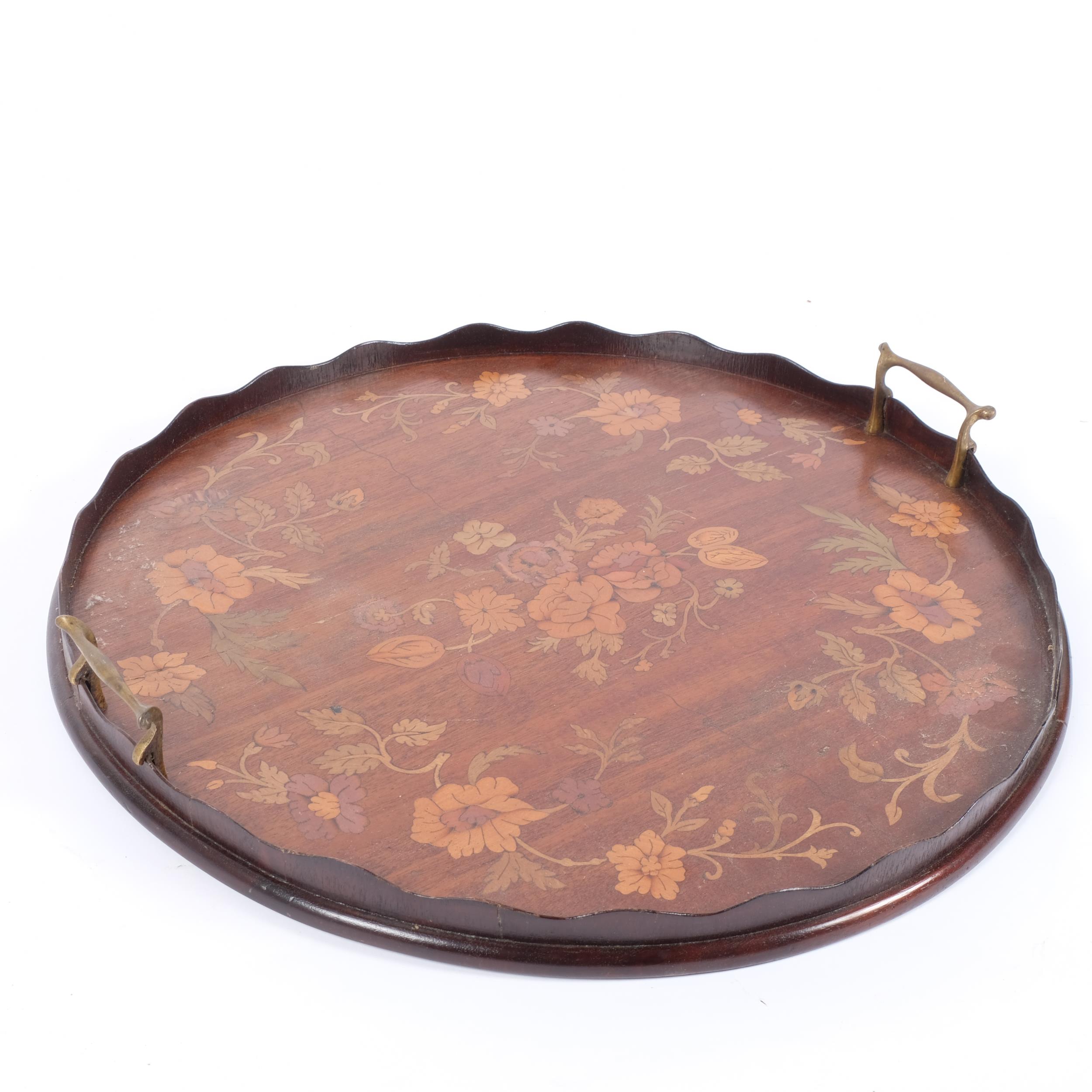 An Edwardian mahogany circular galleried tea tray with brass handles, and floral painted decoration, - Image 2 of 2