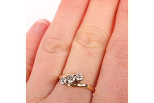 An 18ct gold three stone diamond crossover ring, claw set with modern round brilliant-cut - Image 3 of 3