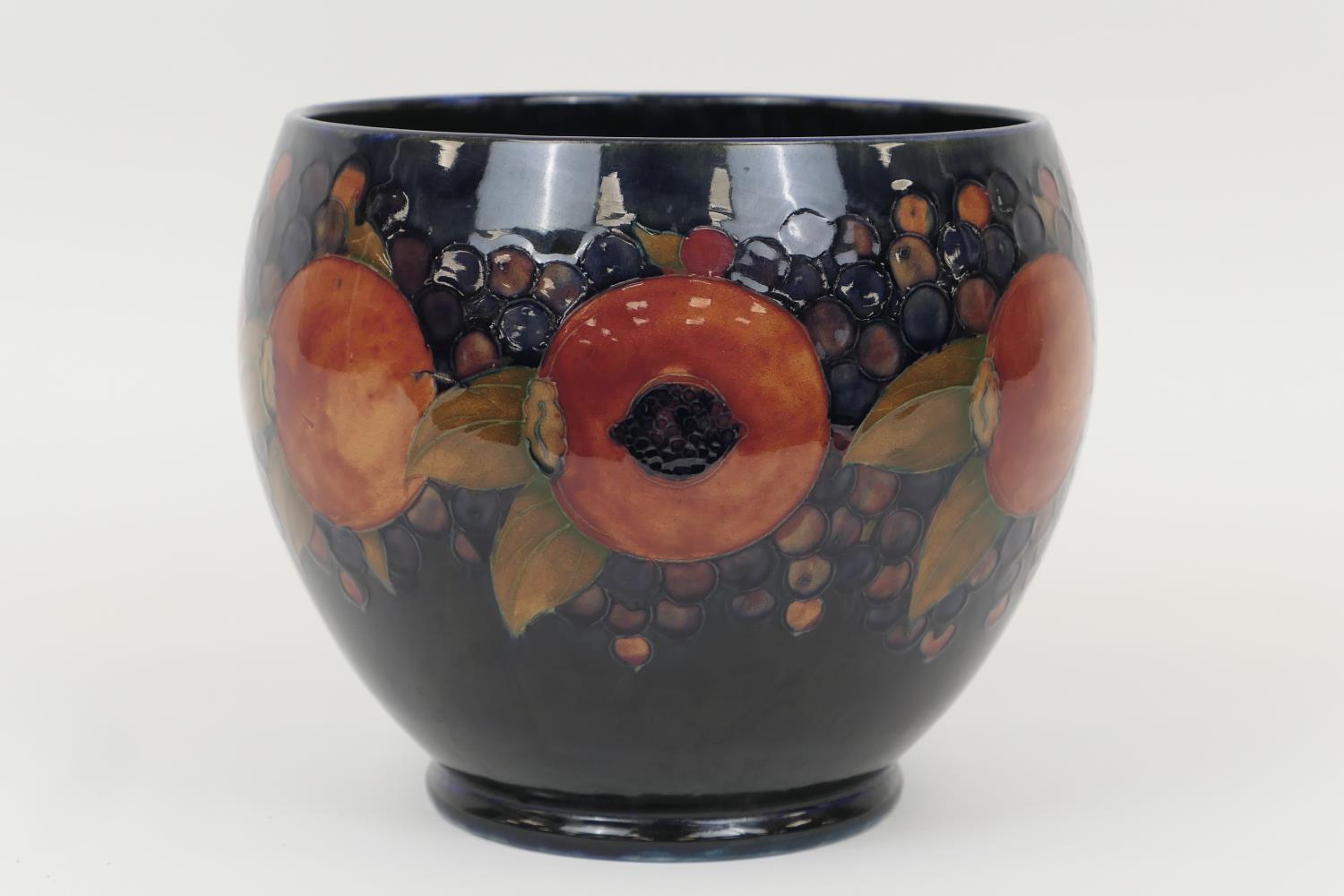 William Moorcroft Pomegranate jardiniere, baluster form with a wide neck, decorated with a deep blue