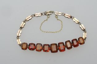 Edwardian gem set bracelet, set with nine amber coloured cushion cut stones (untested), in