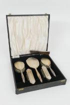 Elizabeth II silver vanity set, Birmingham 1958, cased, in Art Deco style, comprising mirror, two