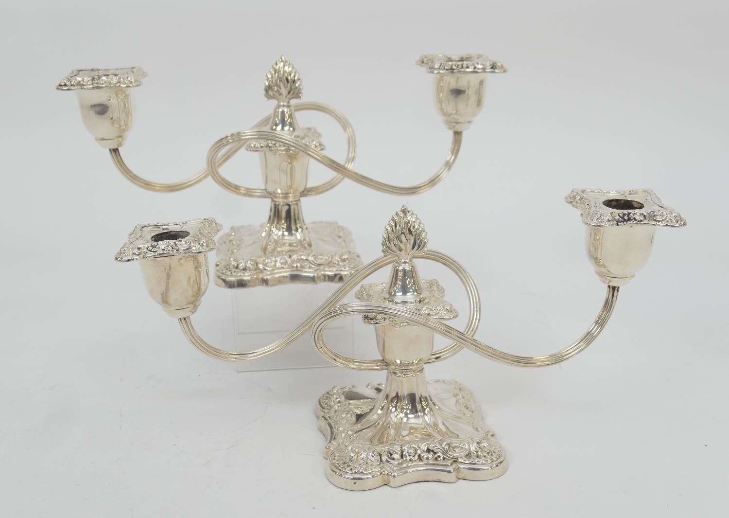 Pair of Victorian silver plated dwarf candelabra, each with two S-shaped branches over a shaped