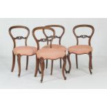 Set of four Victorian walnut balloon back dining chairs, circa 1870, with a carved centre bar,