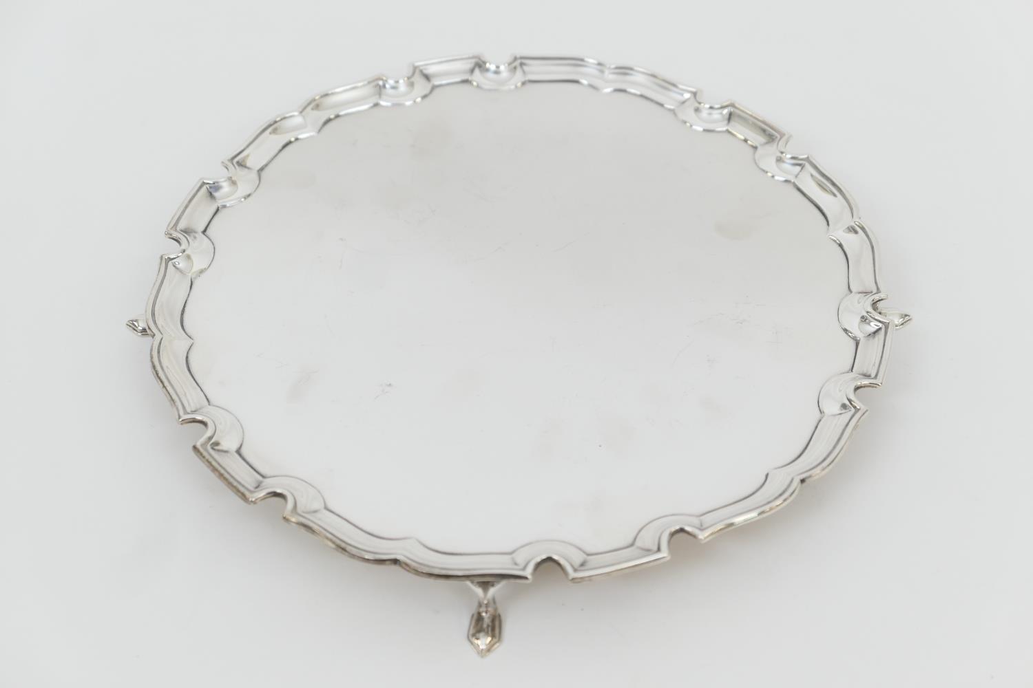 George VI silver salver, London 1937, circular form with raised border, on four pointed feet, 25.5cm