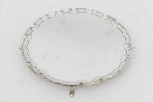 George VI silver salver, London 1937, circular form with raised border, on four pointed feet, 25.5cm