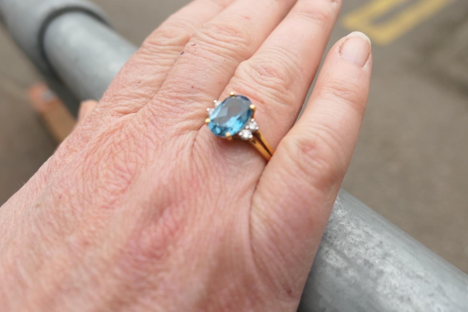 Diamond and blue zircon dress ring, the central oval cut stone of approx. 3cts, bordered with four - Image 3 of 7