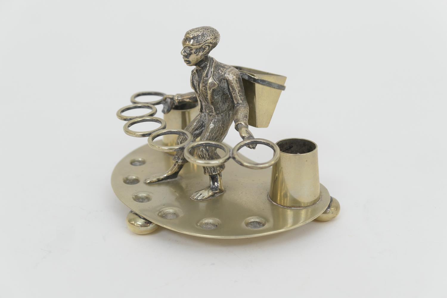 Unusual electroplated pipe stand, late 19th Century, centred with a tobacco leaf picker, width