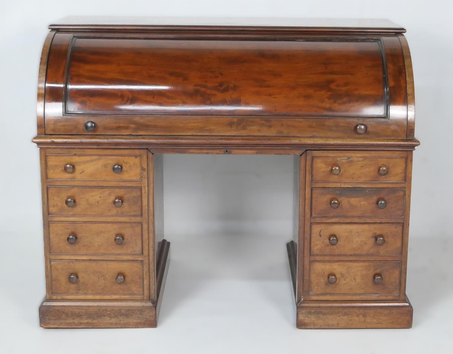 Victorian mahogany cylinder front desk, circa 1870, barrel front lifting to reveal four small
