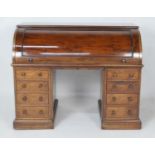 Victorian mahogany cylinder front desk, circa 1870, barrel front lifting to reveal four small