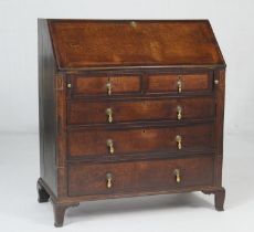 George III provincial oak bureau, circa 1800, sloping top opening to reveal a configuration of