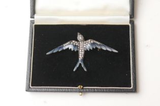 Diamond and enamel swallow brooch, set with 53 small round cut diamonds and cabochon ruby eyes,