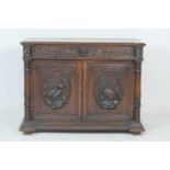 Flemish carved oak side cabinet, late 19th Century, fitted with oak leaf carved frieze drawers
