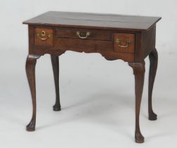 Provincial oak lowboy, circa 1820-40, three plank top fitted with two short and one long central
