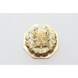 18ct gold octagonal brooch, centred with an Aztec style figure, 25mm diameter, weight approx. 12.