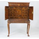 Queen Anne style walnut cabinet on stand, having a moulded cornice with barrel fronted frieze drawer