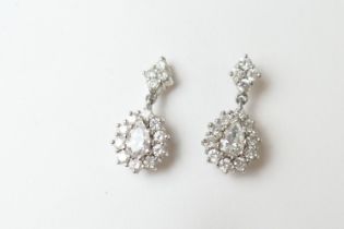 Pair of diamond cluster pendant earrings, each centred with a pear cut diamond of approx. 0.5ct,