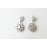 Pair of diamond cluster pendant earrings, each centred with a pear cut diamond of approx. 0.5ct,