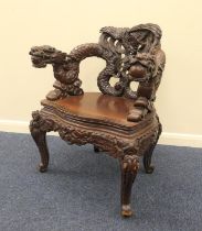 Chinese carved wooden armchair, the back heavily detailed with phoenix, the forearms carved with