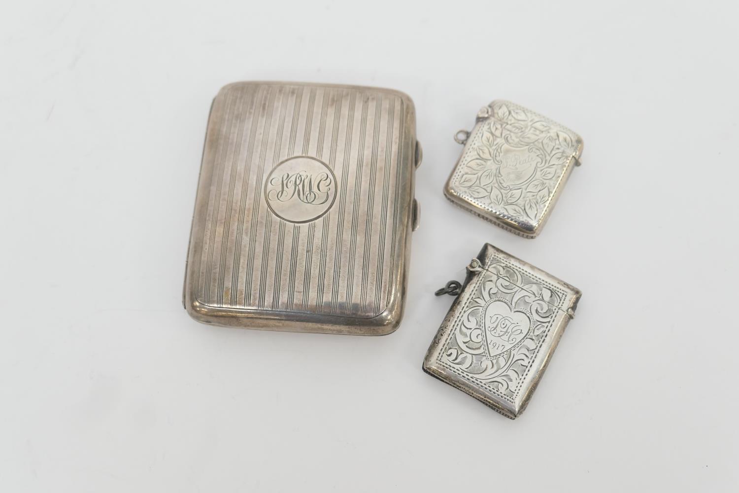 Silver cigarette case, Birmingham 1911, curved form with linear decoration, 8.5cm; also two silver