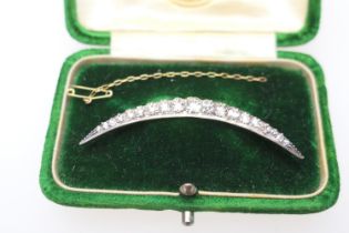 Diamond crescent brooch, set with nineteen old round cut diamonds, the largest centre stone of