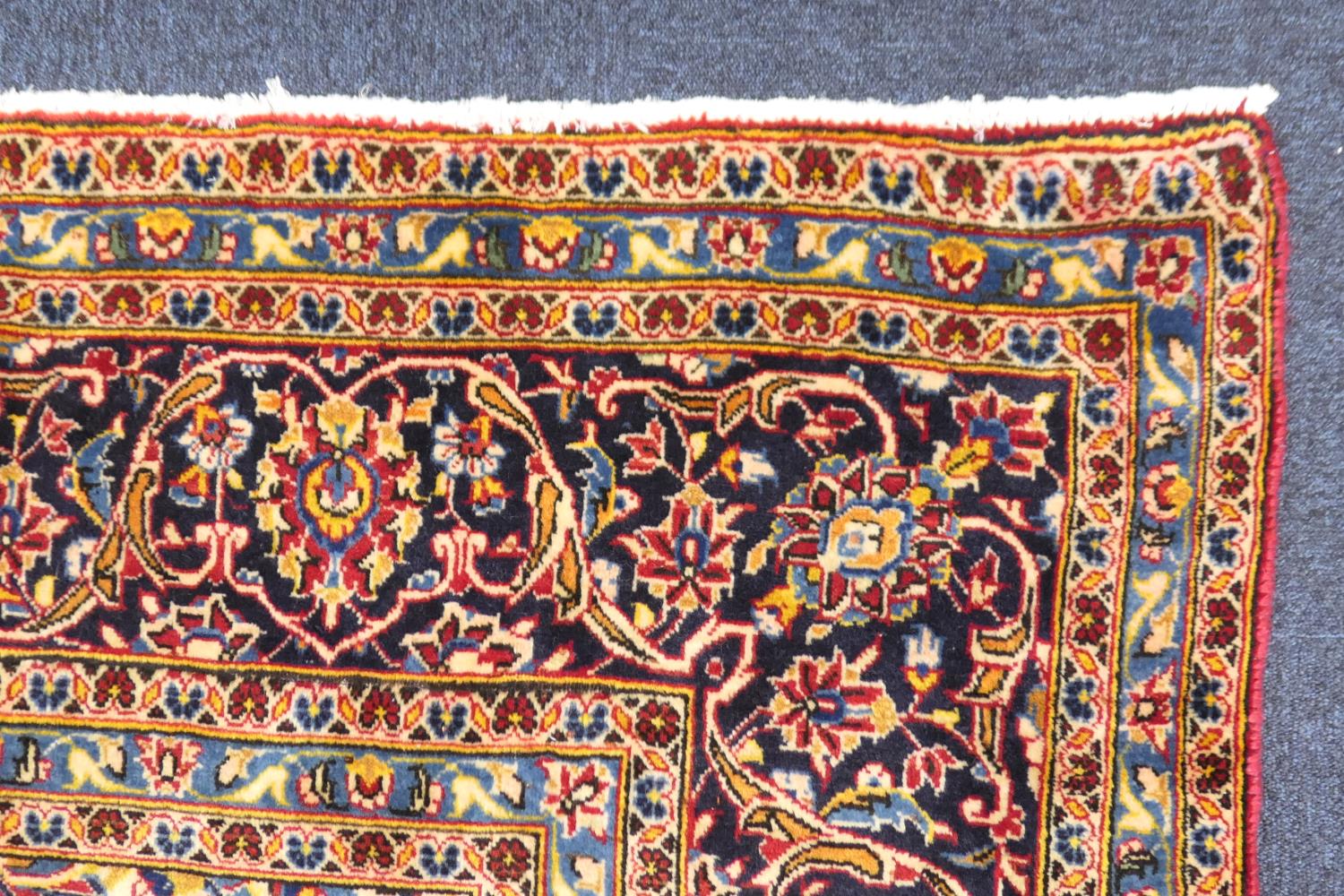 Kashan deep red ground woollen carpet, centred with a blue and fawn medallion, the field dispersed - Image 4 of 4