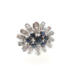 Sapphire and diamond cluster ring, in 18ct white gold, centred with an oval sapphire of approx. 0.