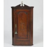 George III mahogany and inlaid hanging corner cupboard, circa 1790, with architectural broken dentil