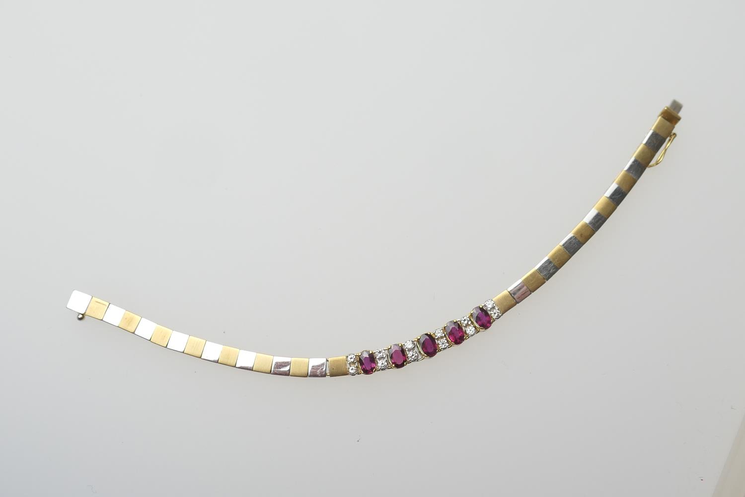 Diamond and ruby bracelet, in 18ct two colour gold, set with five oval cut rubies dispersed with