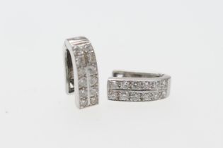 Pair of diamond earrings, each having a double row of channel set round brilliant diamonds in