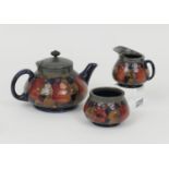 William Moorcroft Pomegranate three piece tea service, comprising teapot with hammered pewter mounts