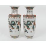 Matched pair of Chinese famille verte rouleau vases, 19th Century, decorated with figures at play in