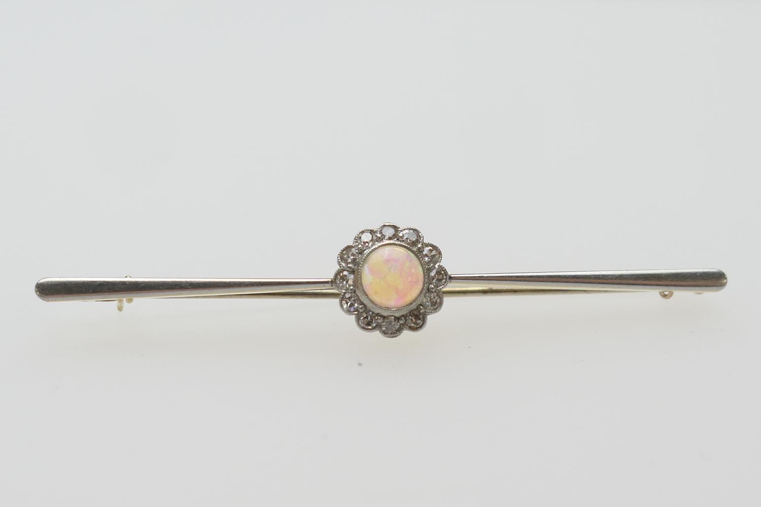 Edwardian opal and diamond bar brooch, in 15ct gold, the central cabochon opal in a millegrain