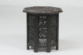 Indian carved hardwood octagonal table, circa 1900, profusely carved with vine leaves throughout,