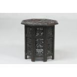 Indian carved hardwood octagonal table, circa 1900, profusely carved with vine leaves throughout,