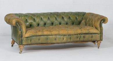 Green deep buttoned leather upholstered chesterfield style settee, with a low back and serpentine