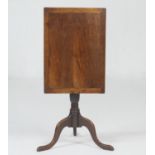 Provincial fruitwood tilt top tripod table, the rectangular top tilting over a turned urn column and