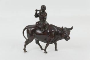 Chinese bronze incense burner, modelled as a boy riding a bull whilst playing a flute, circa 1900 (