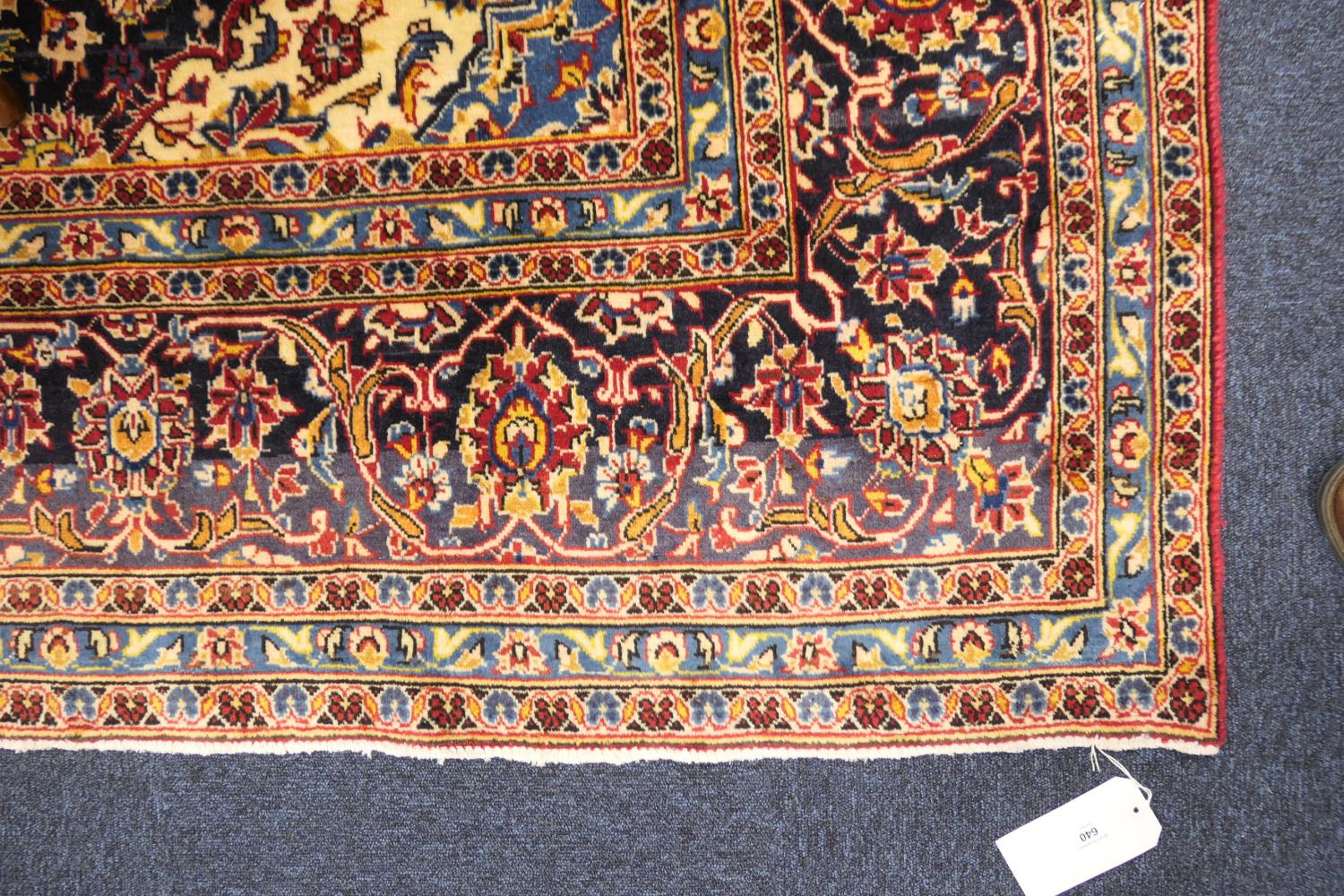 Kashan deep red ground woollen carpet, centred with a blue and fawn medallion, the field dispersed - Image 3 of 4