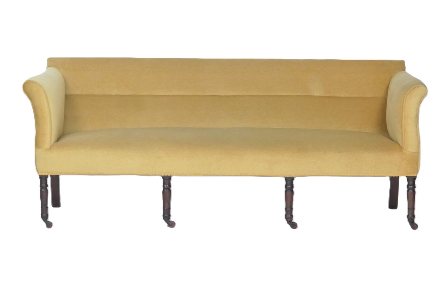 Mahogany gold fabric upholstered settee, early 19th Century, raised on turned and ringed legs with