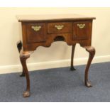 Queen Anne style walnut lowboy, feather banded top with kick-in corners, over three drawers with