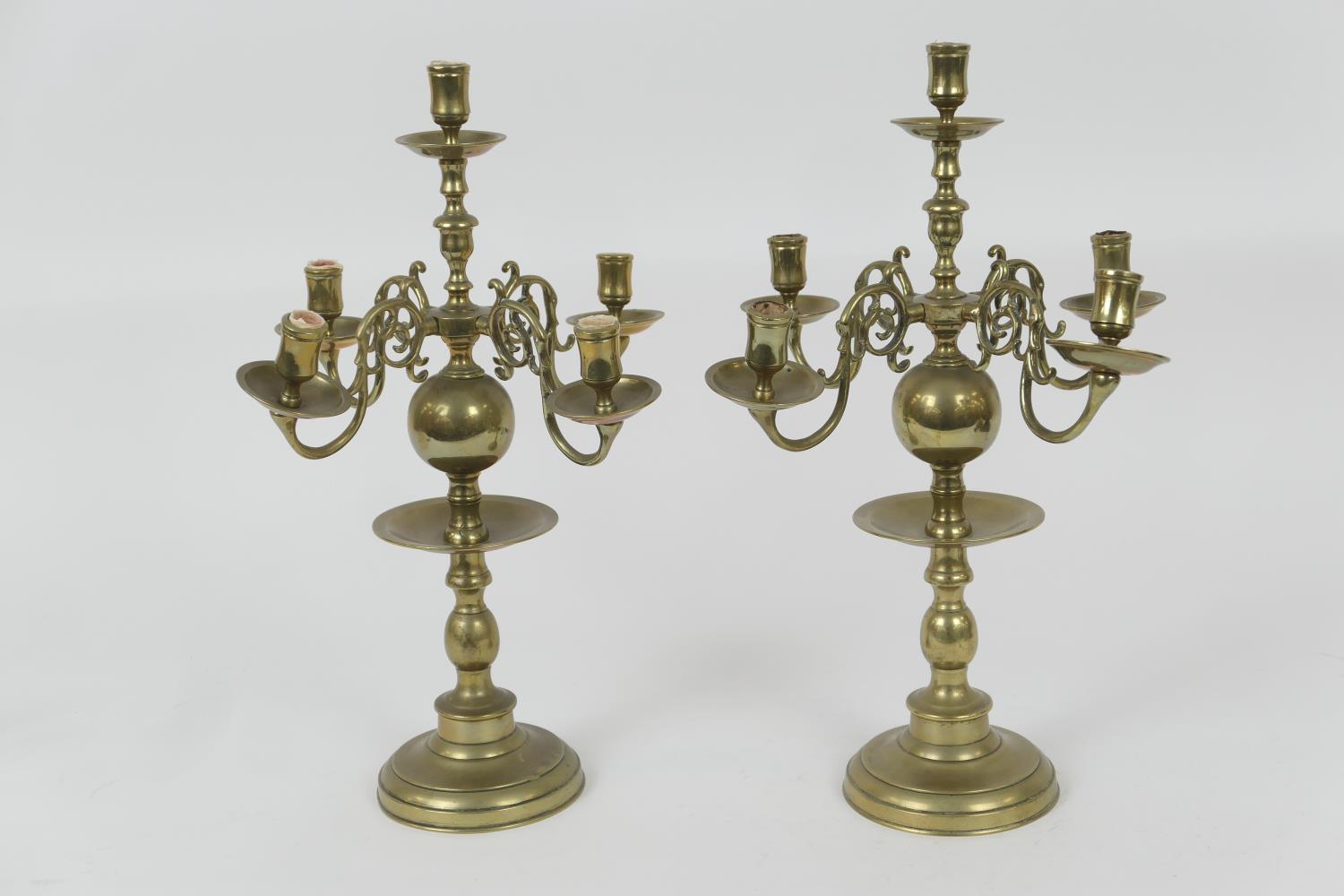 Pair of Dutch brass candlesticks, each with five sconces over multi-knopped columns with drip