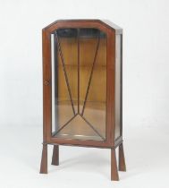 Art Deco mahogany display cabinet, circa 1935-40, with a sunburst astragal glazed door, opening to