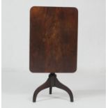 Mahogany tilt top tripod table, the rectangular top over a turned baluster column and three umbrella